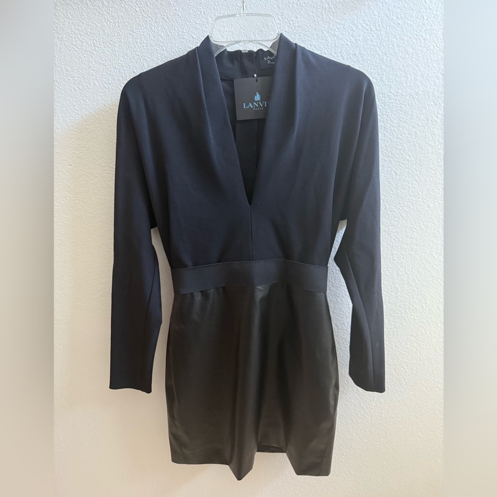 Beautiful black faux leather mini long sleeve dress. Deep v neckline.